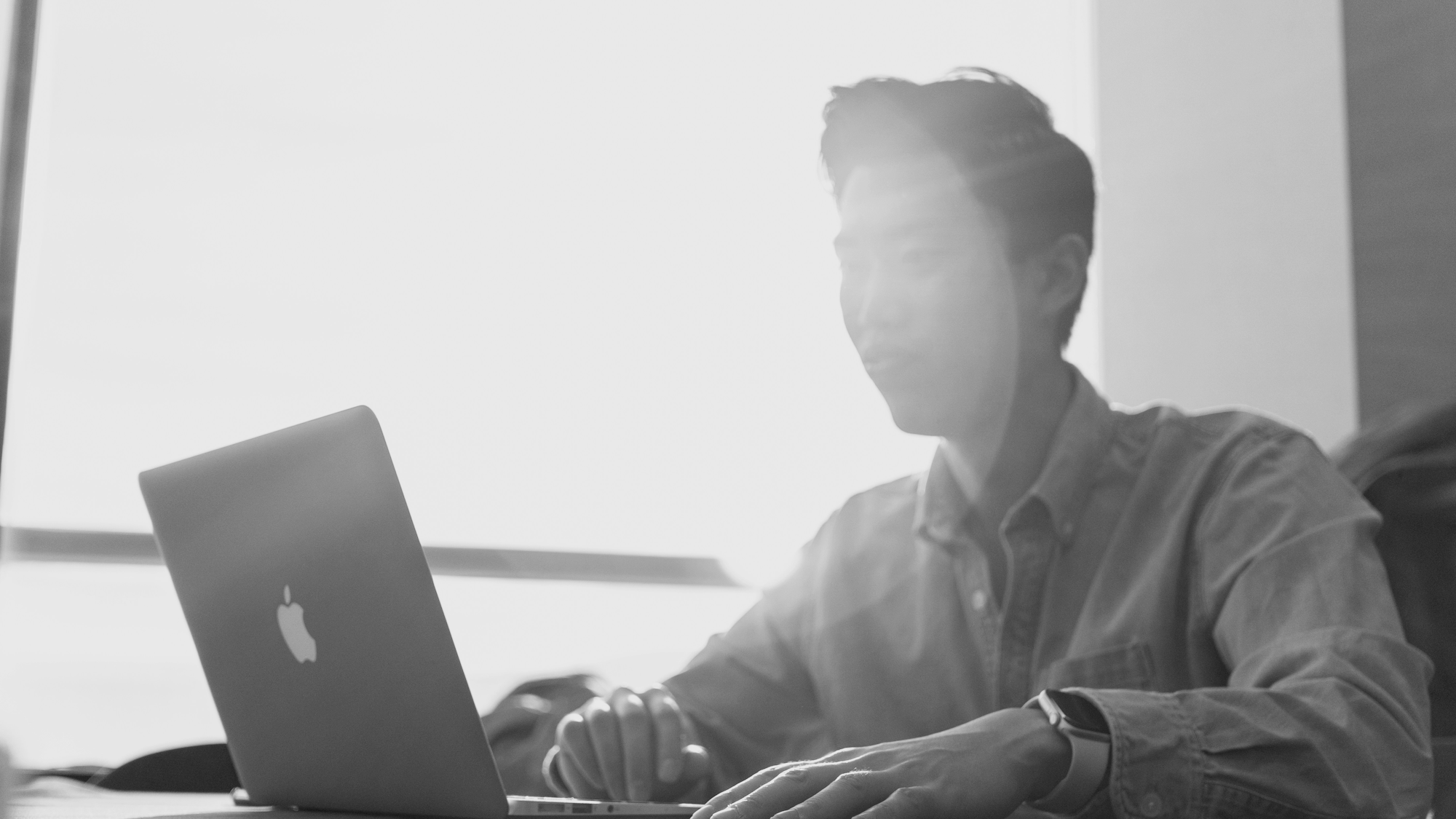 Picture of a student working on a laptop.
